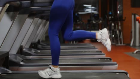 woman exercising on treadmill in gym