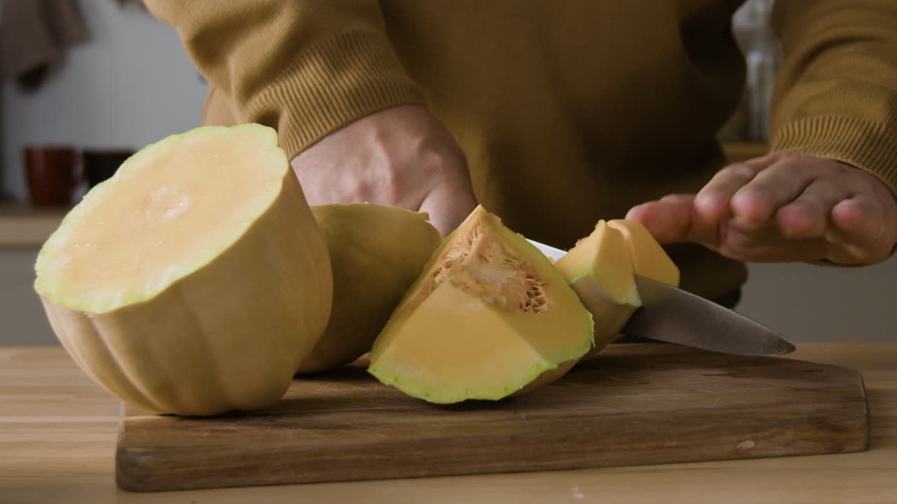 Cutting butternut squash in the kitchen