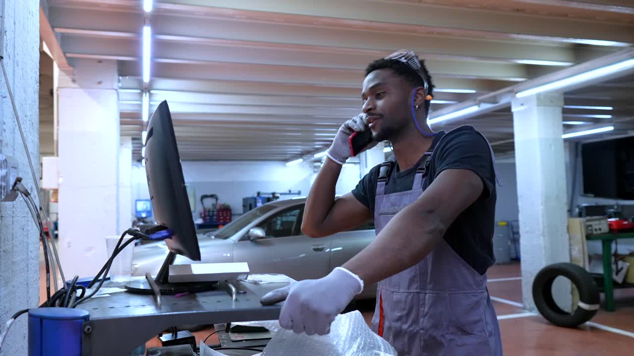 Mechanic on the Phone at Auto Repair Shop