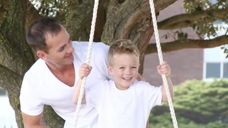 Cerca-De-Padre-Y-Un-Hijo-Balanceándose-En-Un-Parque.