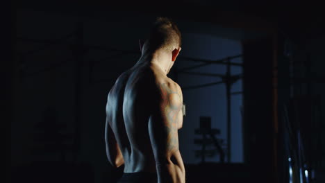 man doing dumbbell bicep curls in gym