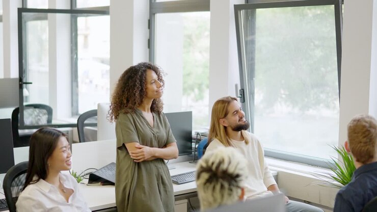 Manager explaining an idea to a friendly team of coworkers