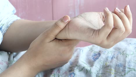 woman checking wrist pulse