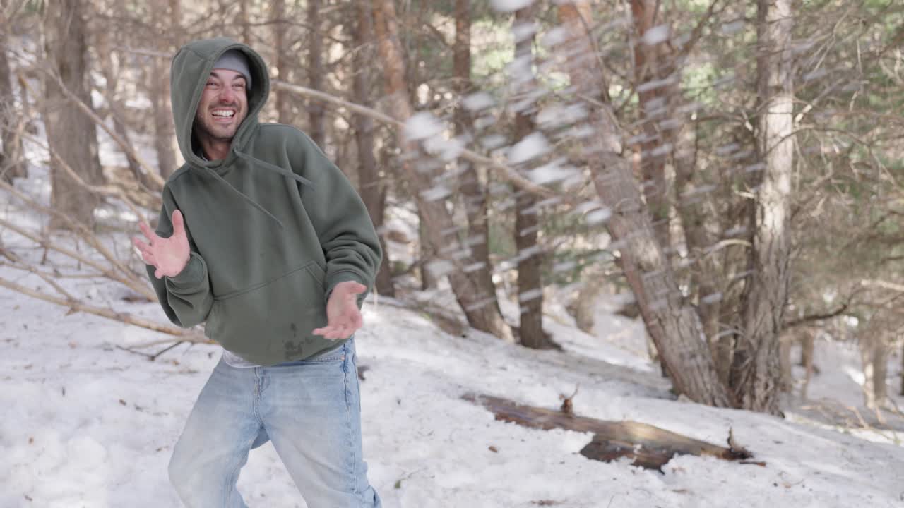 Man Playing in the Snow in the Forest