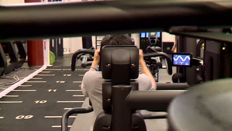man working out on exercise machine in gym