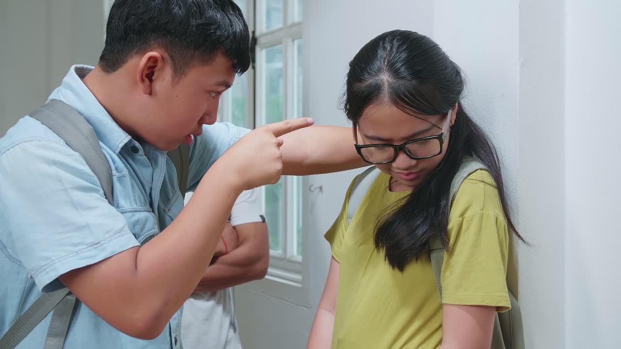 Young Asian Students Bullying Caucasian Girl In Glasses