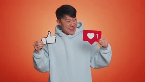 asian adult man raises thumbs up banner thumbs up agrees with something gives positive feedback