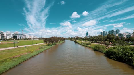 time lapse of people walking by and ships sailing in an urban river, with cloudy sky