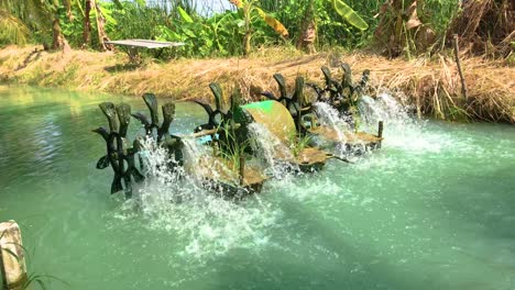 small water purification machine working in a small canal farming at an organic farm in thailand