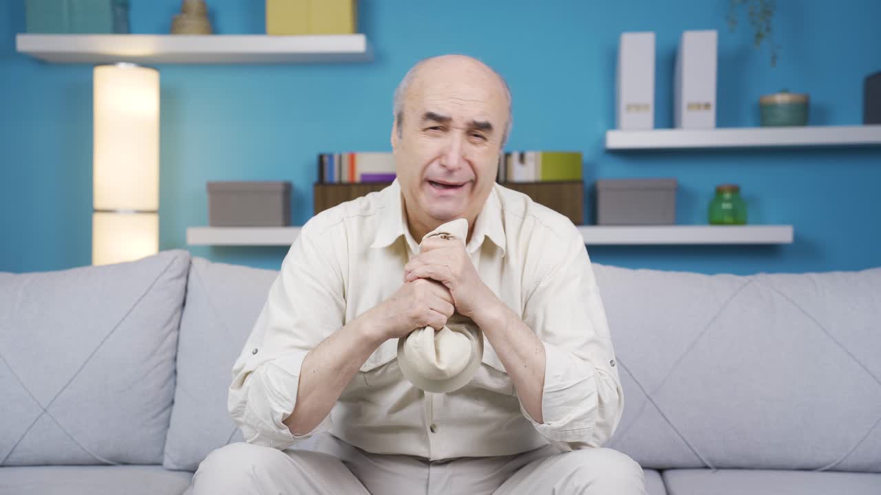 혼자 집에 앉아 울고 있는 좌절한 노인.