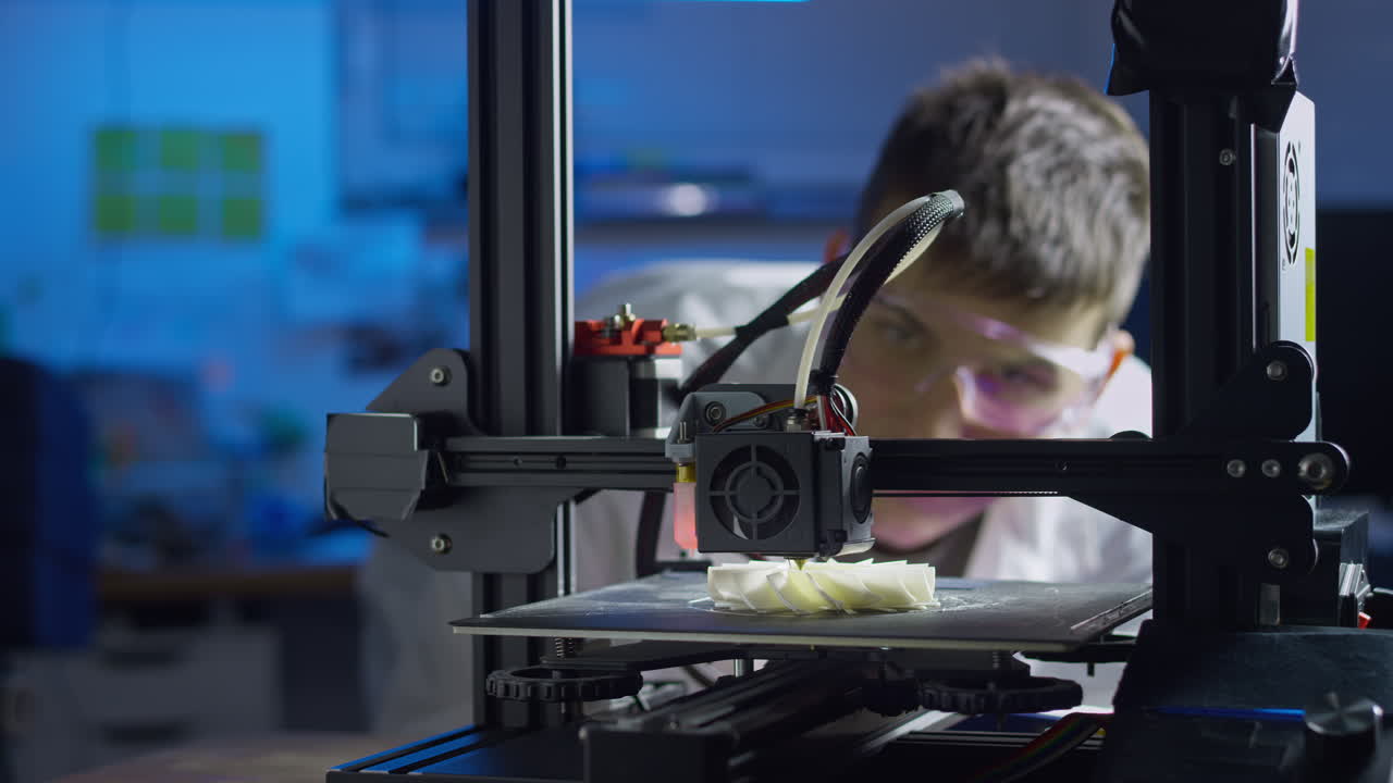 Professional engineer observes the 3d printing process in a modern laboratory while adjusting the