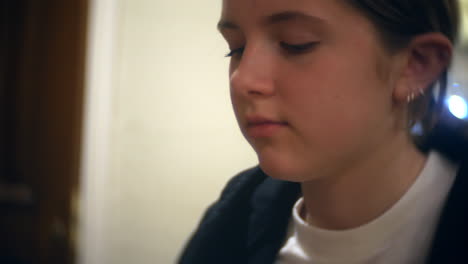 a teenage girl drinking a drink in a restaurant through a straw