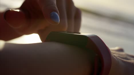 american woman with wearable technology monitoring fitness program