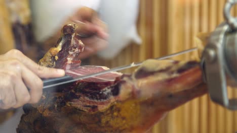 butcher slicing ham