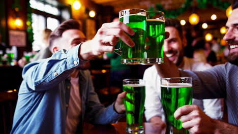 friends celebrating st. patrick's day with green beer in a pub