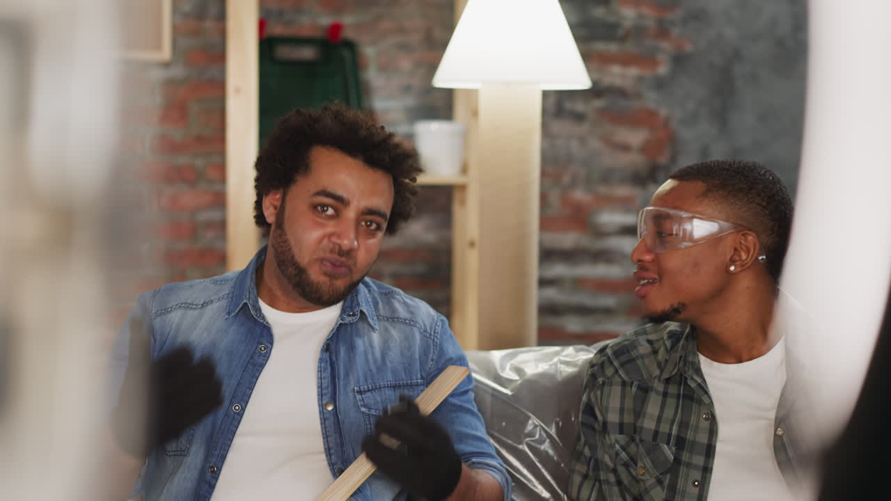 Afro-American man with colleague shoots vlog about repair