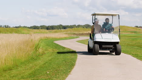 caucasian woman and african american man on the golf course.