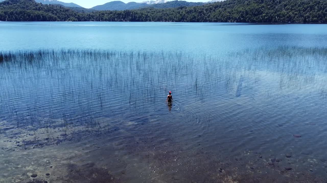 woman quietly exploring the waters of amazing lake in a very calm atmosphere