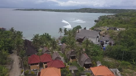 flyover of cliff top tourist resort on bali, and indian ocean beyond