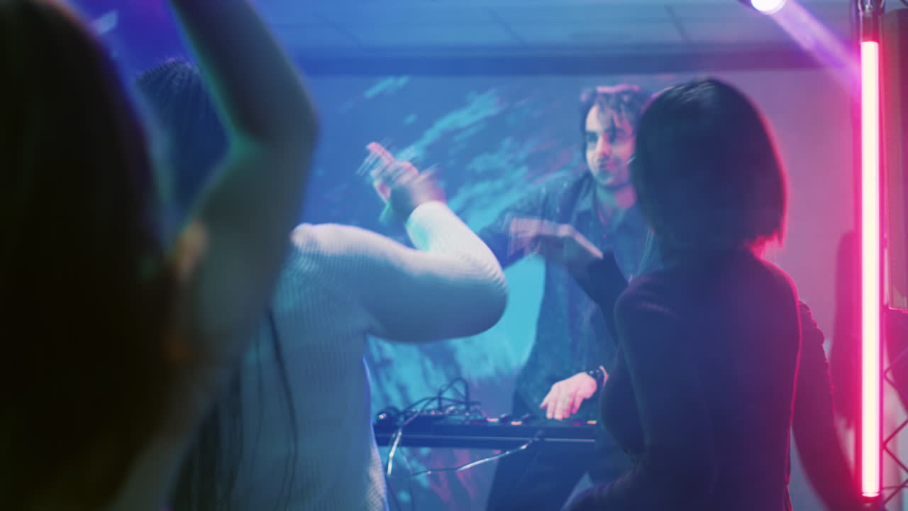 People dancing and a DJ performing at a party
