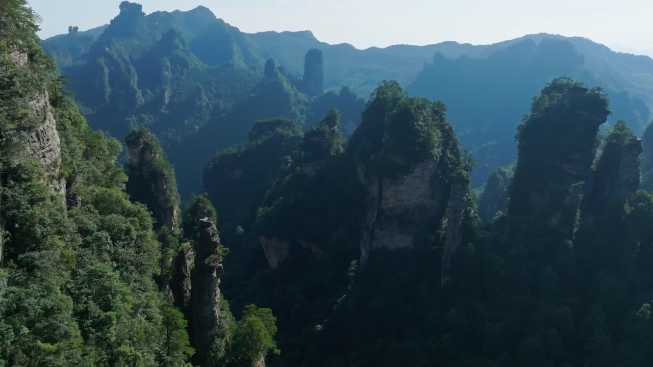 Drone flying near limestone peaks in the Zhangjiajie natural forest park, China