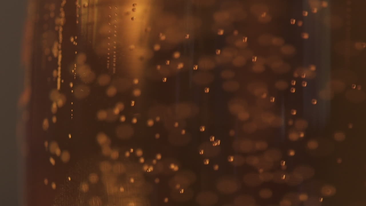 Close Up Macro Shot Bubbles Rising Slowly in pint of beer