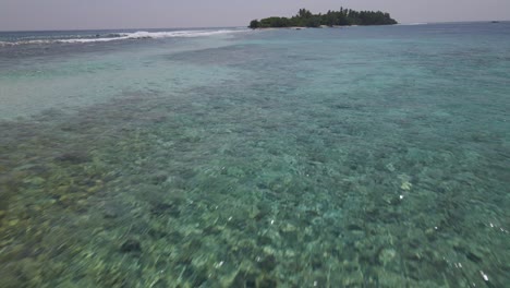 fast moving drone shot of a tropical island in the maldives