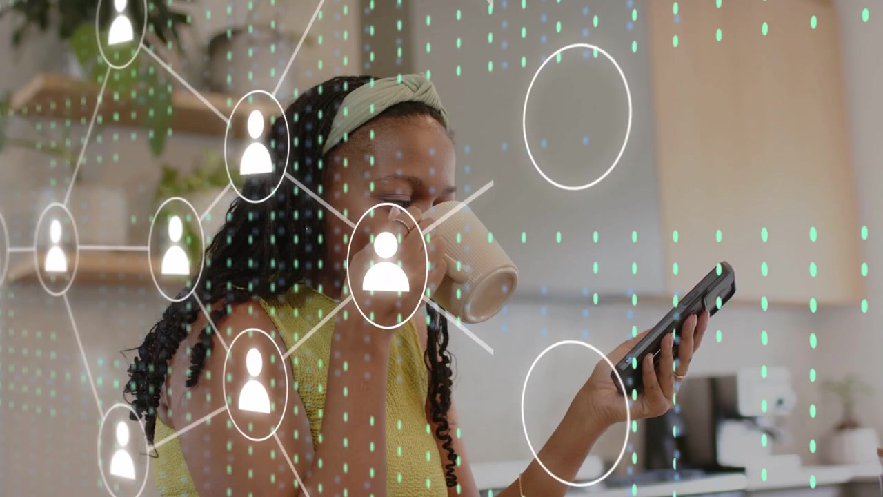 Woman at kitchen counter sipping mug and checking messages, causing tech overlay with user icons