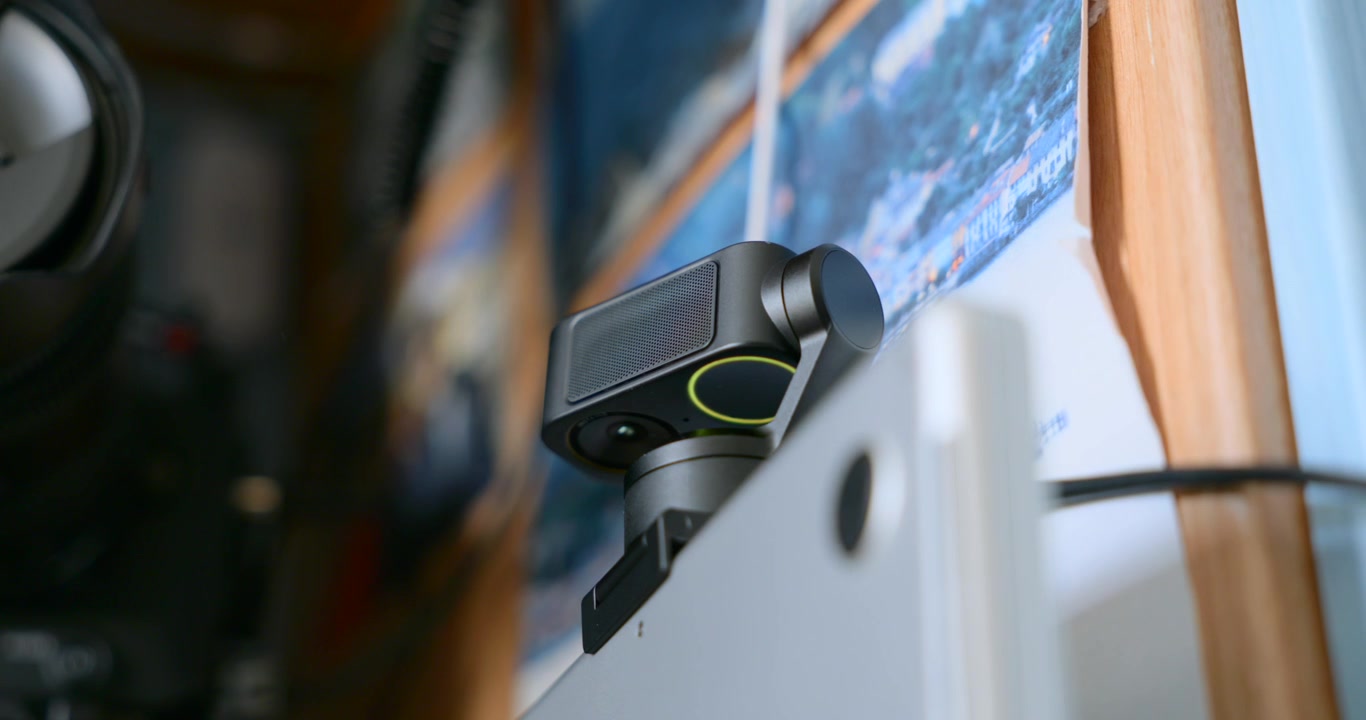 Close-up of Insta360 Link 2 Pro AI webcam attached to top of laptop monitor