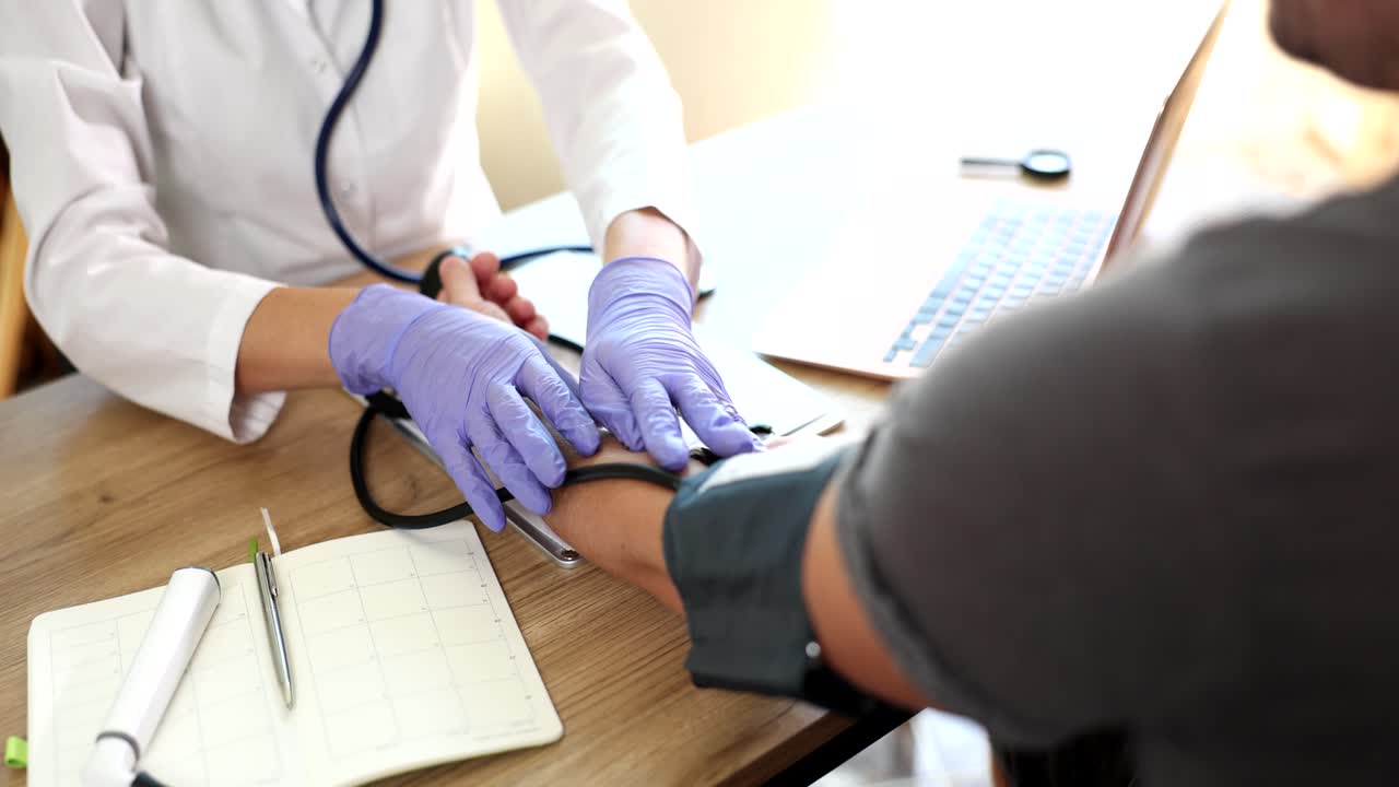 Doctor checking patient's blood pressure