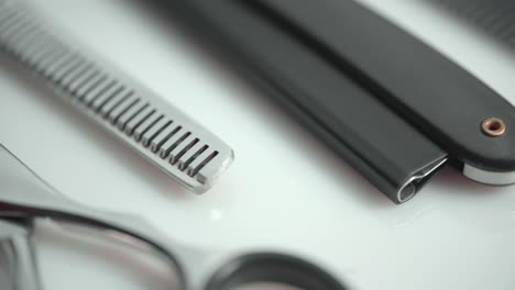 macro shot of hairdressing scissors and tools, rotating on white background