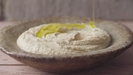 olive oil falling into hummus