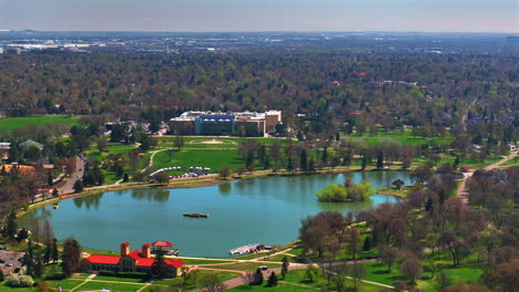 ferril lake denver zoo museum of nature and science city park golf course spring downtown cityscape aerial drone colorado green lush grass sunny blue skies morning neighborhood forward pan up motion