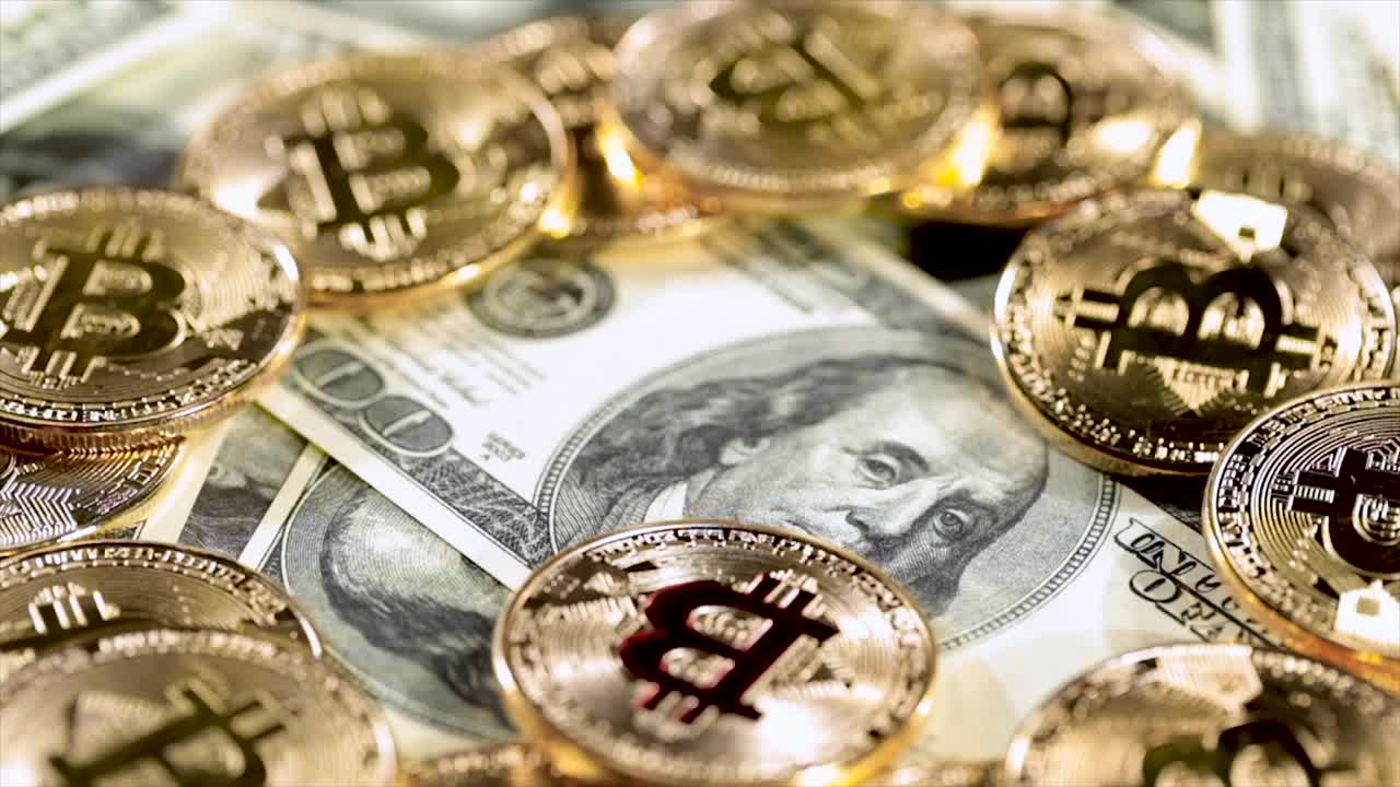 Gold Bit Coin BTC coins and dollar bills.