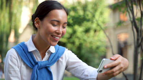 cheerful woman having a video call outdoors