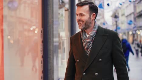 Mature-man-looking-at-window-display