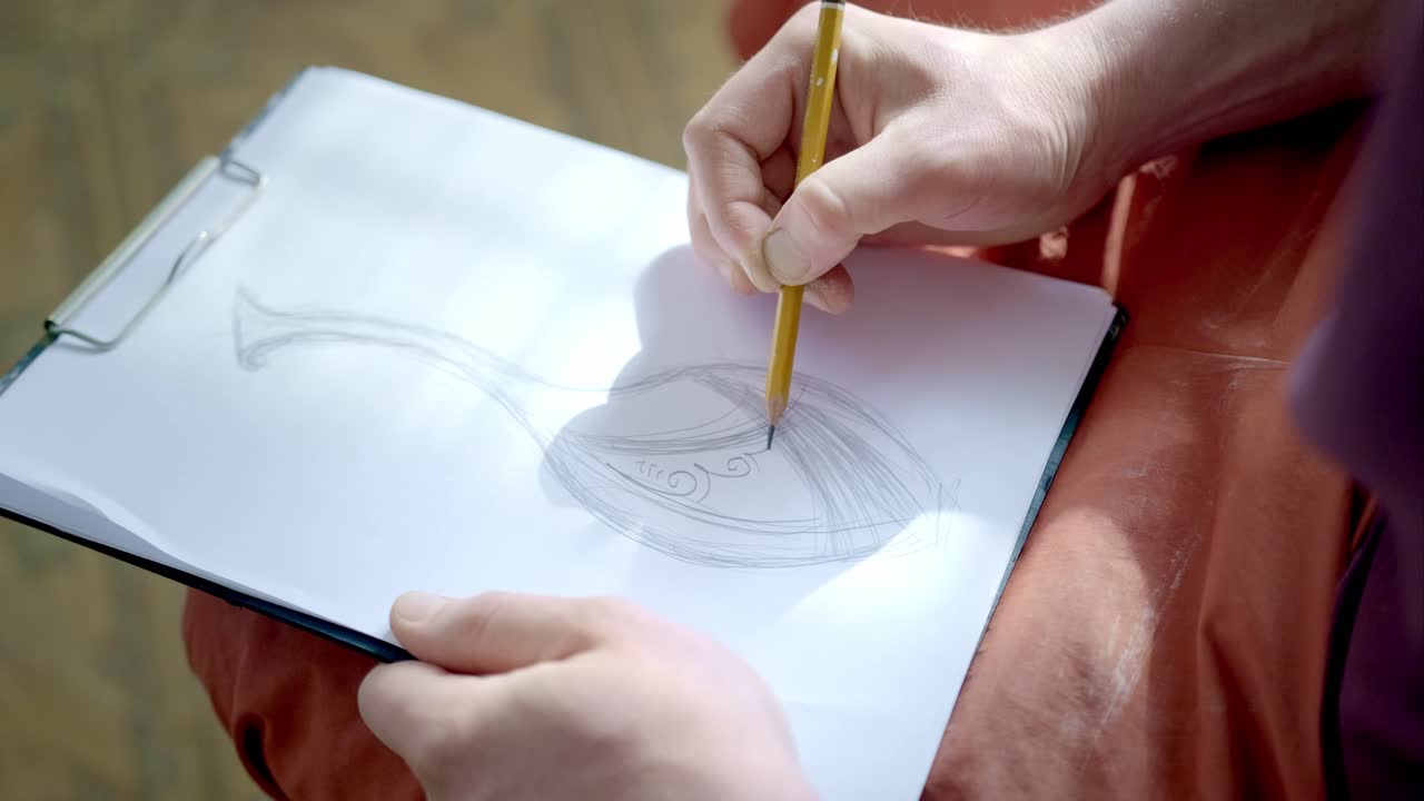 Person drawing a sketch of a wine glass