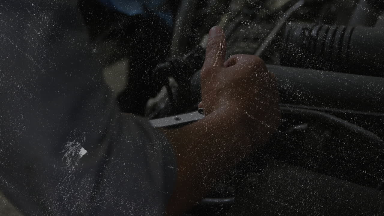 mechanic adjusting engine hose inside auto garage, with floating airflow graph and tubing icons