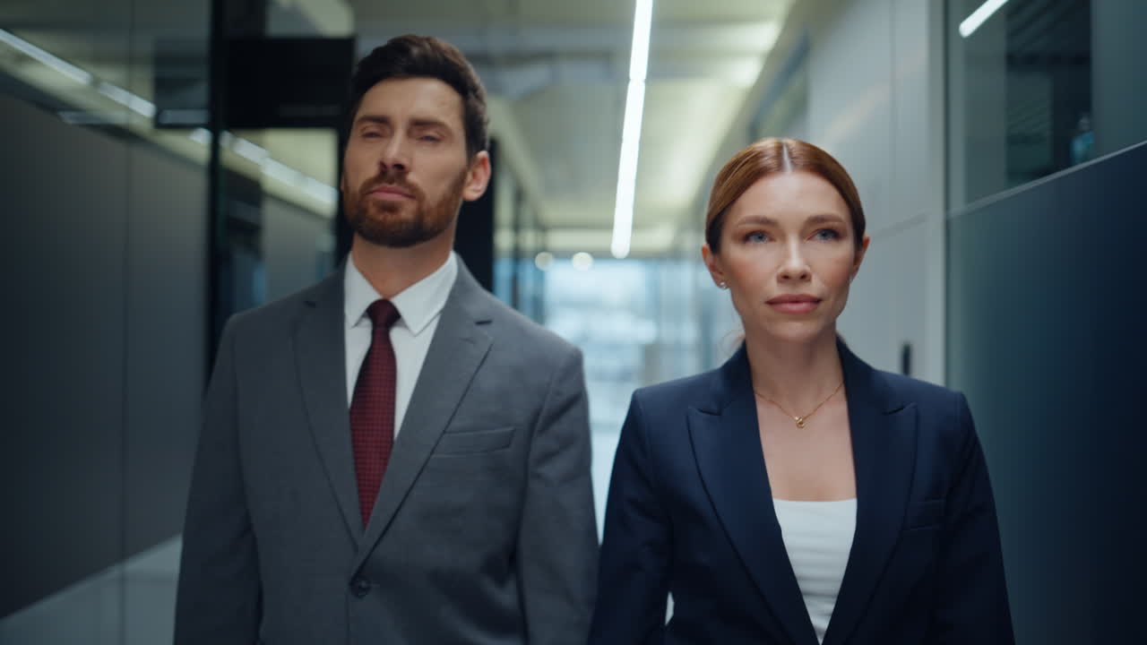 Business partners walking office vestibule portrait. Colleagues looking camera