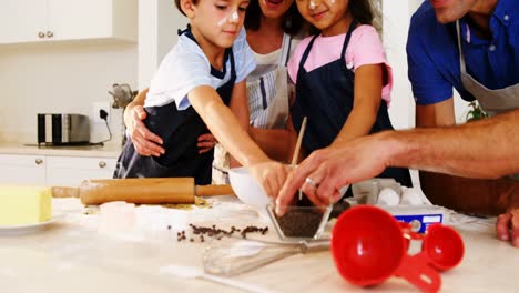 Happy-family-preparing-cookies-in-kitchen