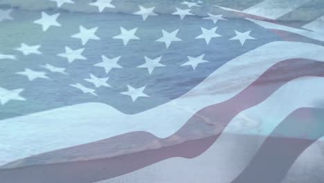 Digital-composition-of-waving-us-flag-against-aerial-view-of-the-beach-and-sea-waves