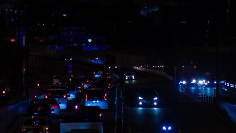 a night timelapse of the traffic jam at the city street in tokyo long shot