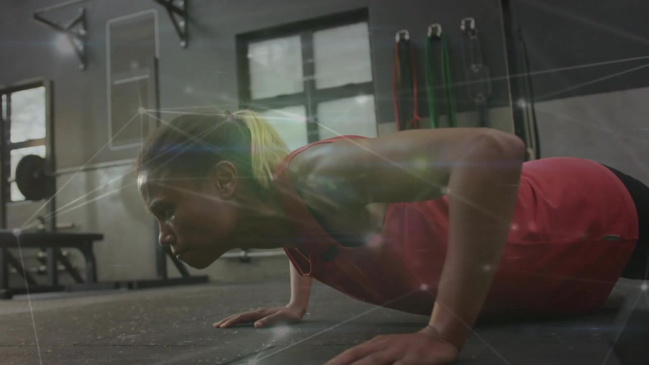 Woman starting plank, doing push-ups on rubber gym floor, activating overlay for fitness training