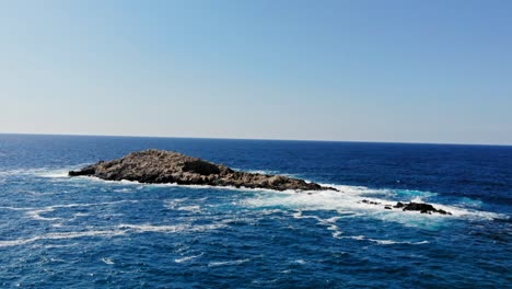 ocean waves splashing on the rocks at jerusalem beach, erisos, greece - aerial drone slow motion shot