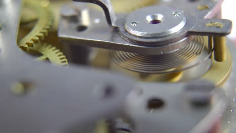 clockwork mechanism of retro clock rotating cogwheels gears close up