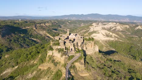 aerial descending shot reveals civita di bagnoregio, lazio, italy