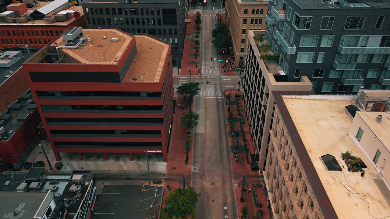 Denver, USA, 28 luglio 2025: volo sopra i tetti degli edifici a più piani. Strada di Denver, Colorado, USA, con poche persone e auto in movimento