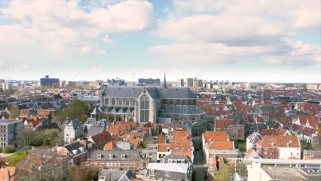 aerial shot flying high over the historical city centre of leiden, the netherlands, with the pieterskerk, leiden university and rapenburg canal
