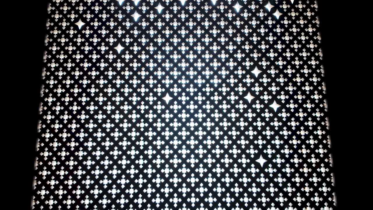 Upward sweep shot against the light of an Arabesque geometric design from the Islamic art collection inside the British Museum in London