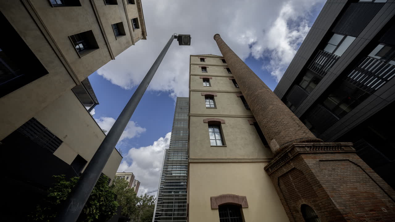 Old factory chimney and apartment buildings in barcelona